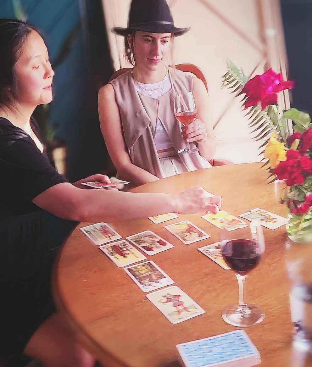 Wei-En laying out tarot cards for a guest at Stem Wine Bar